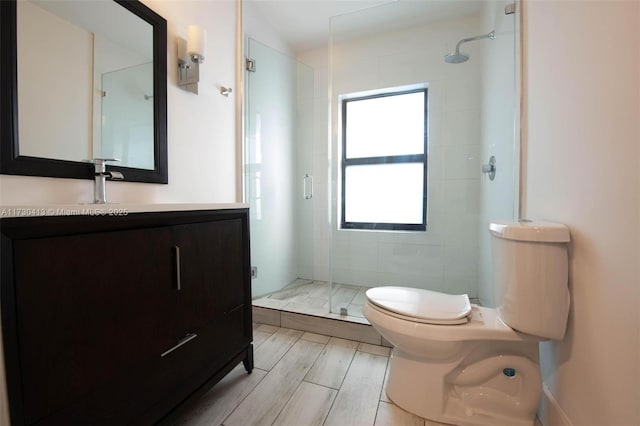 bathroom with vanity, toilet, and walk in shower