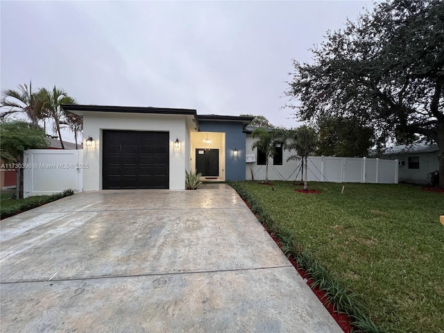 view of front of property featuring a garage and a front lawn