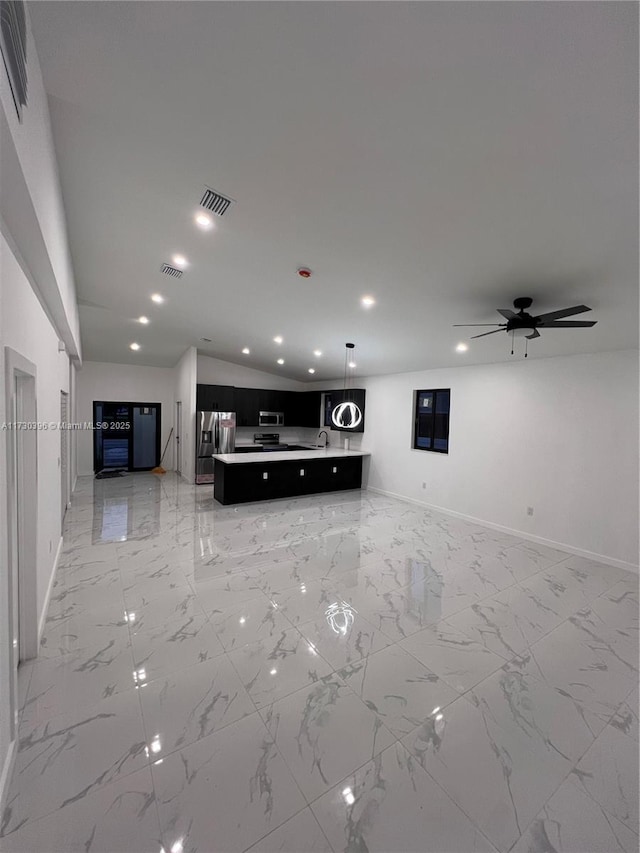 unfurnished living room with ceiling fan and lofted ceiling