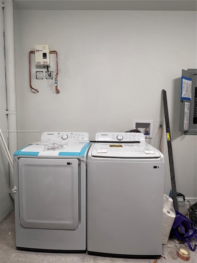 washroom with electric panel and washing machine and dryer