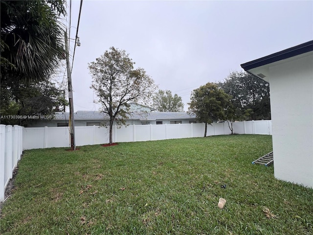 view of yard with a fenced backyard