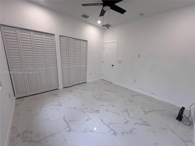 unfurnished bedroom featuring marble finish floor, baseboards, visible vents, and recessed lighting