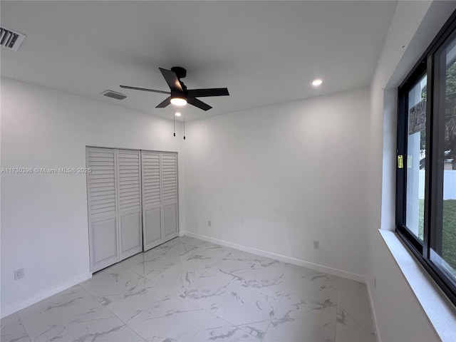 unfurnished bedroom featuring marble finish floor, baseboards, and visible vents