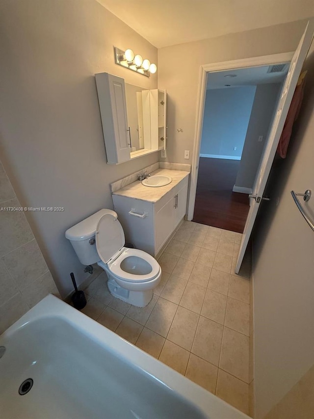 bathroom featuring vanity, toilet, and tile patterned flooring