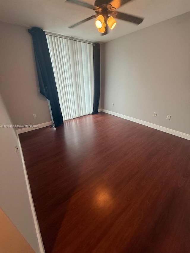 spare room featuring dark hardwood / wood-style floors and ceiling fan