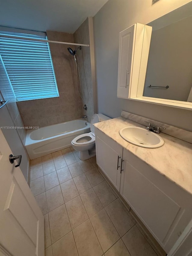 full bathroom featuring tile patterned floors, toilet, vanity, and tiled shower / bath