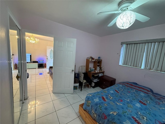 tiled bedroom featuring ceiling fan with notable chandelier