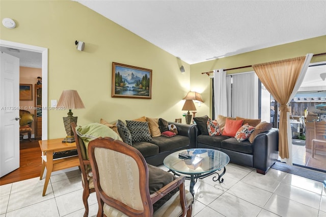 living room with light tile patterned floors and lofted ceiling