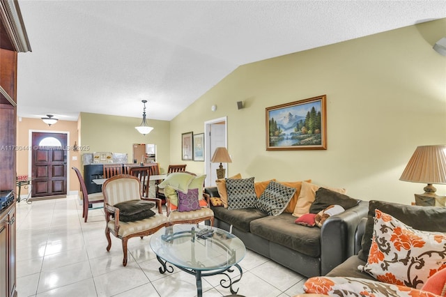 living room featuring vaulted ceiling and light tile patterned floors