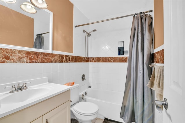 full bathroom with vanity, toilet, tile walls, and shower / bath combo