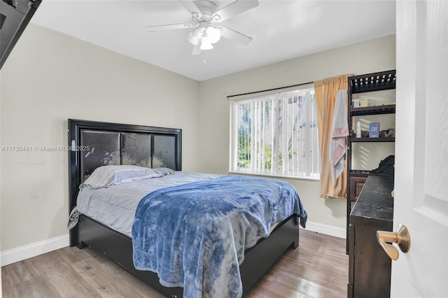 bedroom with ceiling fan and hardwood / wood-style flooring