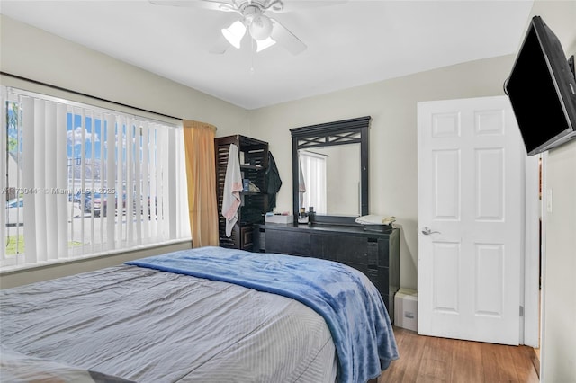 bedroom with ceiling fan and hardwood / wood-style floors