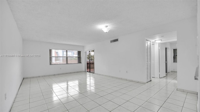 460 W Park Dr Unit 207, Miami, FL 33172 - unfurnished room featuring light tile patterned flooring, a textured ceiling, and visible vents