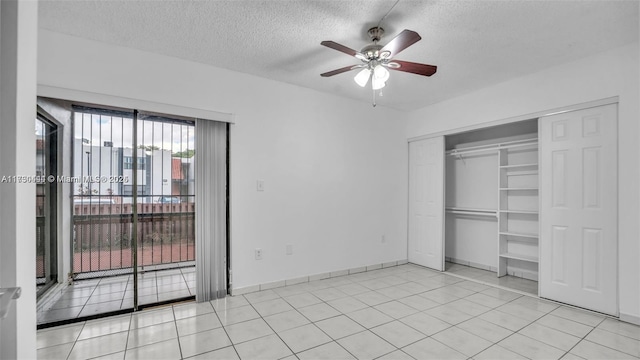 460 W Park Dr Unit 207, Miami, FL 33172 - unfurnished bedroom featuring a closet, a textured ceiling, baseboards, access to outside, and light tile patterned floors