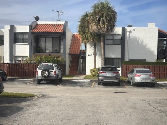 460 W Park Dr Unit 207, Miami, FL 33172 - view of building exterior featuring uncovered parking and fence