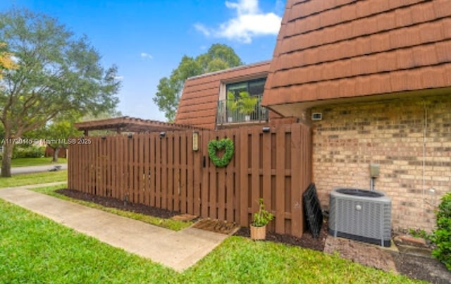 exterior space featuring central AC and a yard