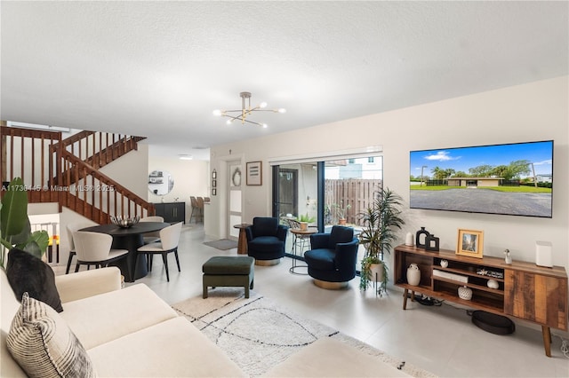 living area featuring an inviting chandelier, stairs, a textured ceiling, and light tile patterned flooring