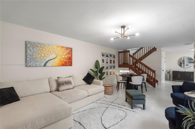 living room featuring visible vents, stairway, a chandelier, and a textured ceiling