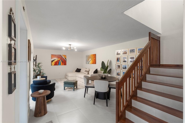 living room with stairway and an inviting chandelier