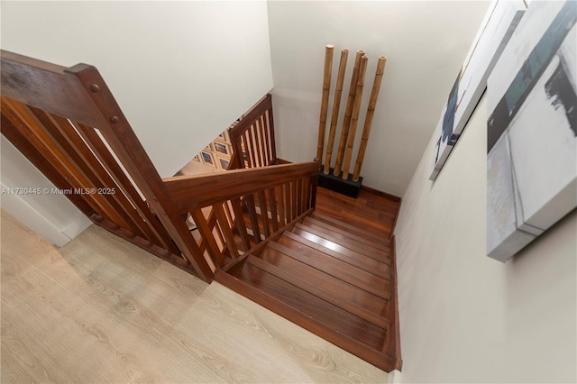 staircase featuring wood finished floors