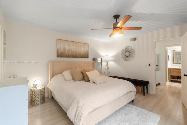 bedroom with a ceiling fan, baseboards, visible vents, and light wood finished floors