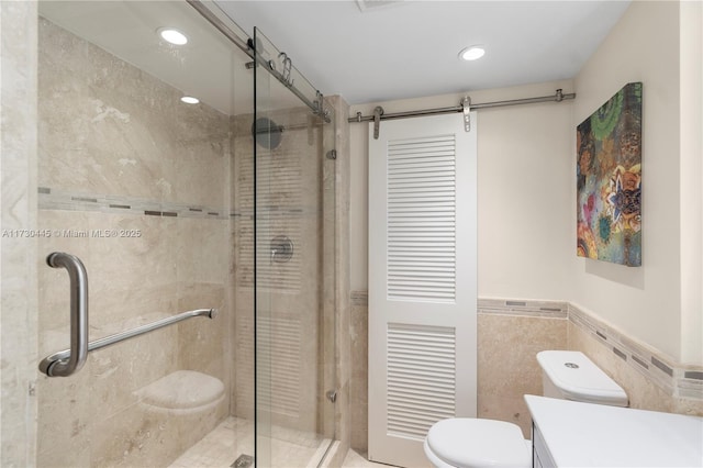 full bathroom featuring toilet, recessed lighting, vanity, tile walls, and a shower stall