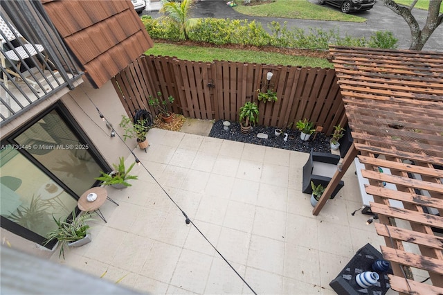view of patio with fence and stairway