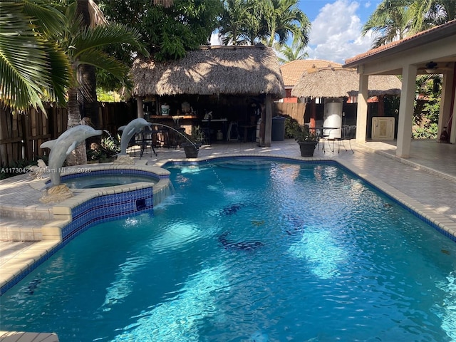 view of swimming pool with an in ground hot tub, an outdoor bar, and a patio area