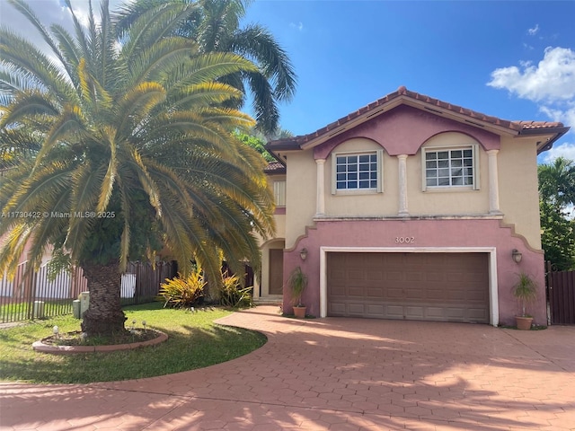 mediterranean / spanish home with a garage