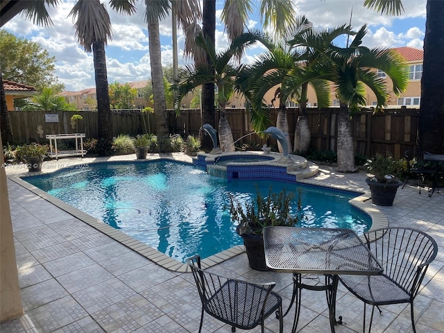 view of swimming pool with an in ground hot tub and a patio