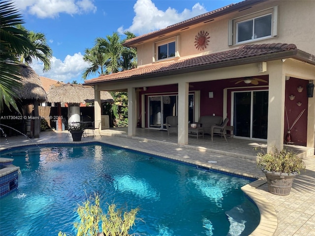 view of pool featuring ceiling fan and a patio area