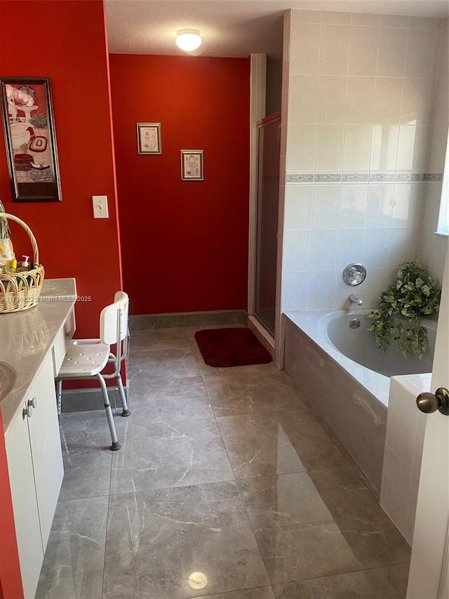 bathroom with separate shower and tub, a textured ceiling, and vanity