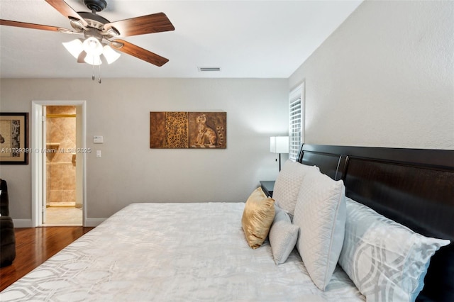 bedroom featuring ceiling fan, ensuite bathroom, and hardwood / wood-style floors