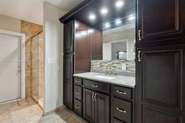 bathroom featuring a shower with shower door, backsplash, and vanity