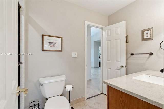 bathroom featuring toilet, tile patterned floors, and vanity