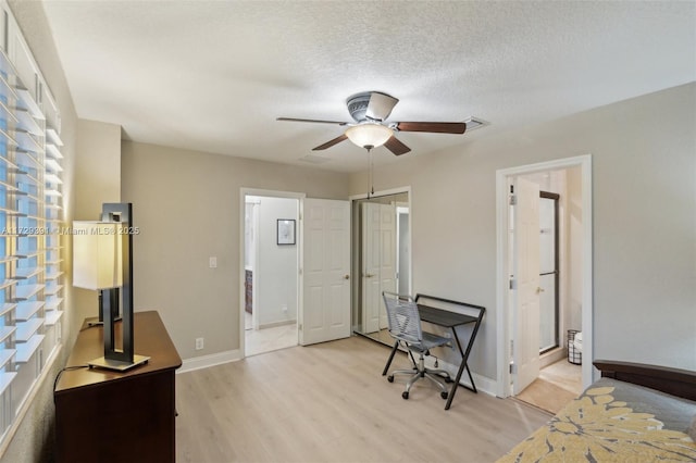 office space with a textured ceiling, light hardwood / wood-style flooring, and ceiling fan