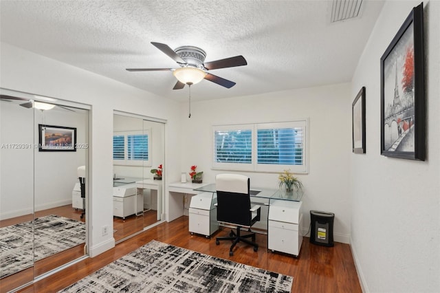 office space with ceiling fan, a textured ceiling, and dark hardwood / wood-style floors