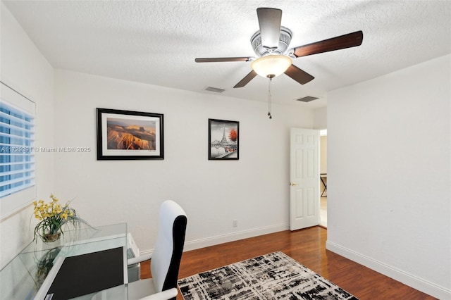 office with ceiling fan, dark wood-type flooring, and a textured ceiling