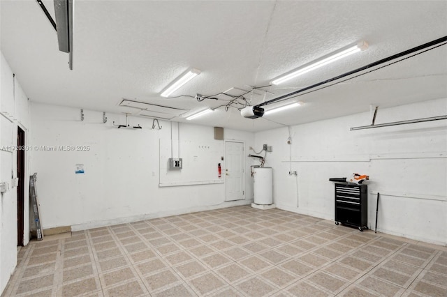 garage featuring water heater and a garage door opener