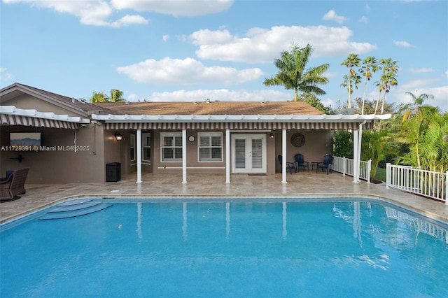 view of pool with a patio area and french doors