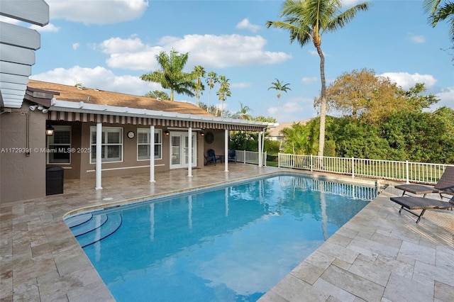 view of swimming pool featuring an outbuilding and a patio area