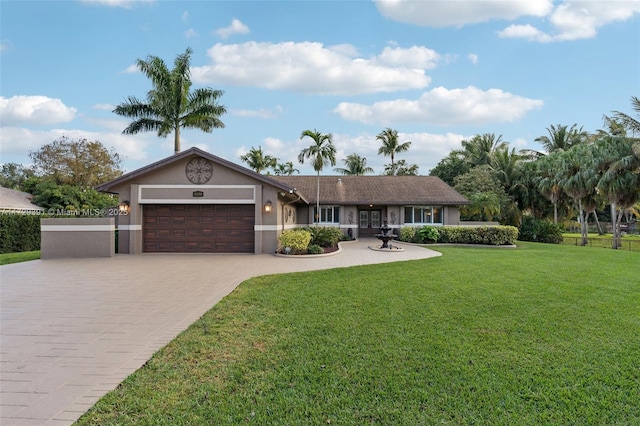 single story home featuring a garage and a front yard