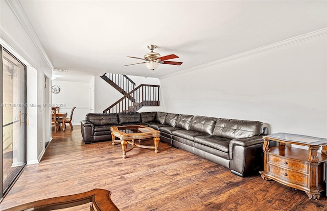 living room with ceiling fan, wood-type flooring, and crown molding