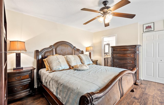 bedroom featuring dark wood-type flooring, connected bathroom, ceiling fan, and a closet