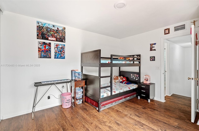 bedroom with wood-type flooring