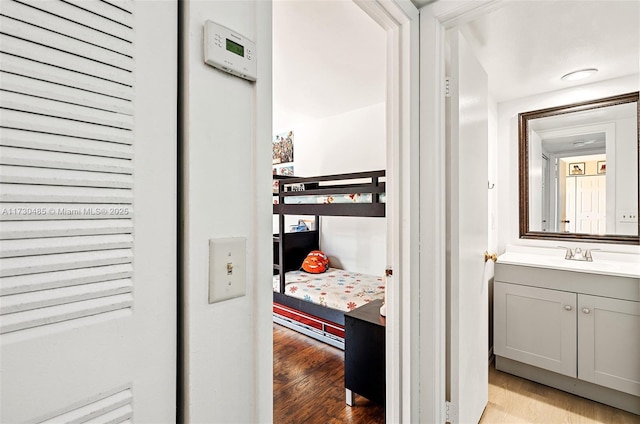 bedroom featuring sink and light wood-type flooring