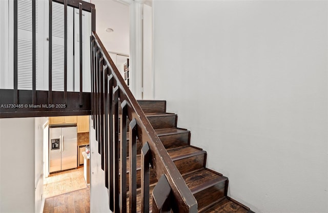 stairway featuring hardwood / wood-style floors