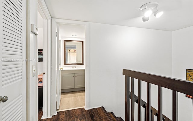 hallway with dark wood-type flooring and sink