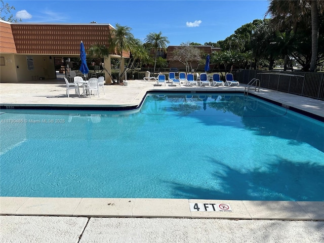 view of swimming pool with a patio