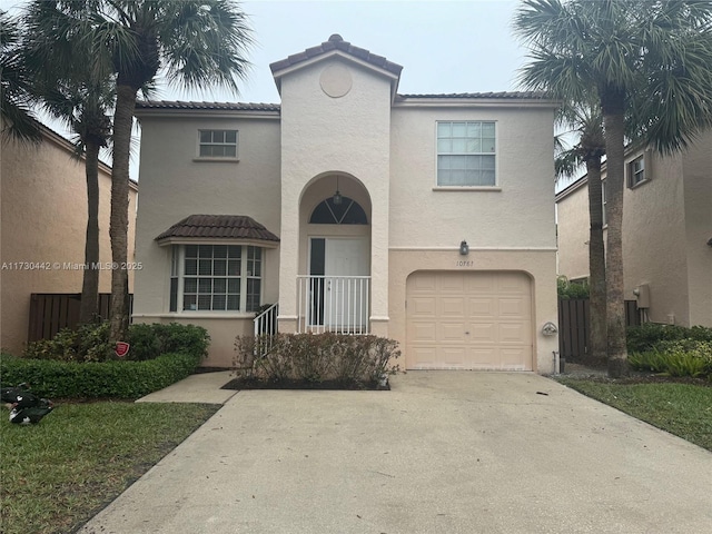 mediterranean / spanish-style home with a garage